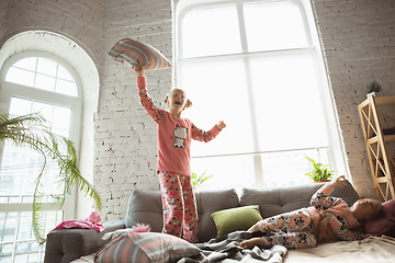 Image showing Quiet little girls playing in a bedroom in cute pajamas, home style and comfort, laughting and fighting pillows