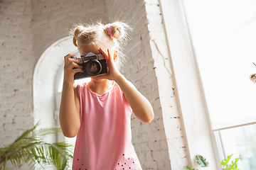 Image showing Little girl playing in a bedroom in cute pajama, home style and comfort, taking a photo, having fun