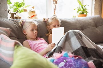 Image showing Quiet little girls playing in a bedroom in cute pajamas, home style and comfort, watching cartoons, cinema, having fun