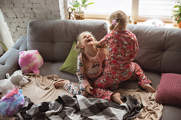 Image showing Quiet little girls playing in a bedroom in cute pajamas, home style and comfort, laughting, having fun together