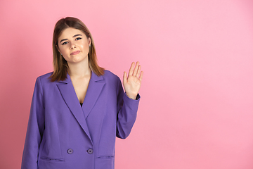 Image showing Caucasian young woman\'s portrait on pink studio background, emotional and expressive