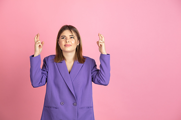 Image showing Caucasian young woman\'s portrait on pink studio background, emotional and expressive