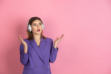 Image showing Caucasian young woman\'s portrait on pink studio background, emotional and expressive