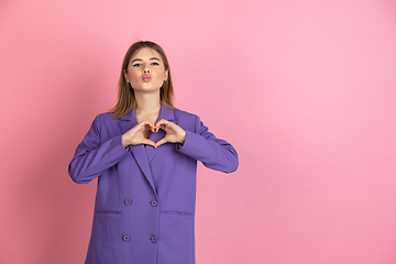 Image showing Caucasian young woman\'s portrait on pink studio background, emotional and expressive