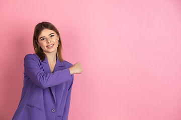 Image showing Caucasian young woman\'s portrait on pink studio background, emotional and expressive