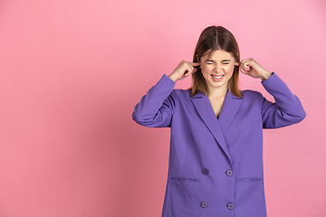 Image showing Caucasian young woman\'s portrait on pink studio background, emotional and expressive