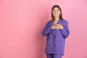 Image showing Caucasian young woman\'s portrait on pink studio background, emotional and expressive