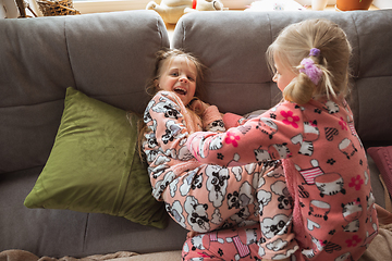 Image showing Quiet little girls playing in a bedroom in cute pajamas, home style and comfort, laughting, having fun together