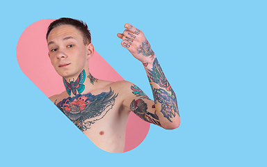 Image showing Portrait of young man with freaky appearance on bright bicolor background with geometric style, modern design, artwork