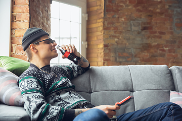 Image showing Portrait of millenial boy using retro toys, meeting things from the past and having fun, exploring tetris game