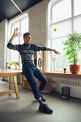 Image showing Portrait of millenial boy using retro toys, meeting things from the past and having fun, exploring yo-yo game