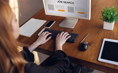 Image showing Close up woman typing while looking for a job during worldwide crisis of coronavirus pandemic. Find a job online. Business, internet and networking concept.