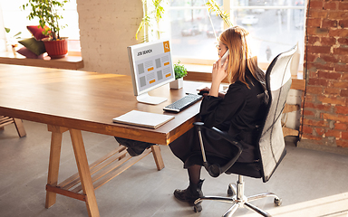 Image showing Woman typing while looking for a job during worldwide crisis of coronavirus pandemic. Find a job online. Business, internet and networking concept.