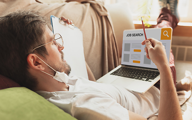 Image showing Man looking for a job during worldwide crisis of coronavirus pandemic. Find a job online. Business, internet and networking concept.