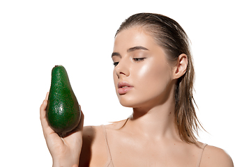 Image showing Shining. Beautiful young woman with fresh avocado over white background. Cosmetics and makeup, natural and eco treatment, skin care.