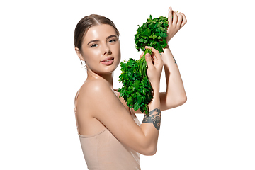 Image showing Healthy. Beautiful young woman with green leaves on her face over white background. Cosmetics and makeup, natural and eco treatment, skin care