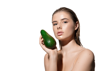 Image showing Fashionable. Beautiful young woman with fresh avocado over white background. Cosmetics and makeup, natural and eco treatment, skin care