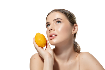 Image showing Dreams. Beautiful young woman with orange over white background. Cosmetics and makeup, natural and eco treatment, skin care.