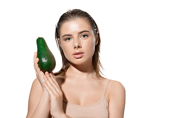 Image showing Shining. Beautiful young woman with fresh avocado over white background. Cosmetics and makeup, natural and eco treatment, skin care.