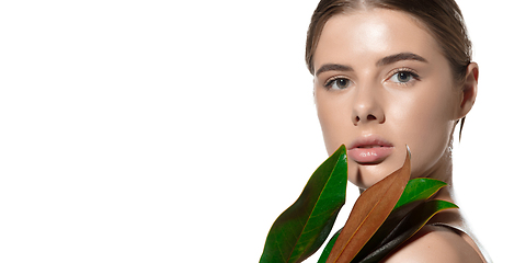 Image showing Prime. Portrait of beautiful young woman with green leaf on her face over white background. Cosmetics and makeup, natural and eco treatment, skin care. Flyer with copyspace.