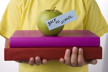 Image showing detail of a kid hands with books, going back to school