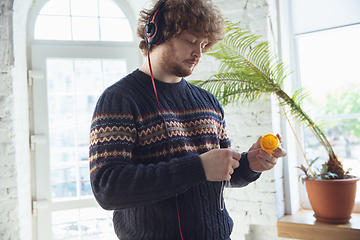 Image showing Portrait of millenial boy using retro toys, meeting things from the past and having fun, nostalgic, playing yo-yo