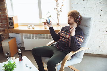 Image showing Portrait of millenial boy using retro toys, meeting things from the past and having fun, nostalgic, listen to music with cassette player