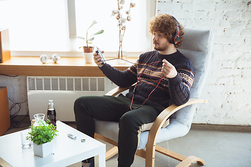 Image showing Portrait of millenial boy using retro toys, meeting things from the past and having fun, nostalgic, listen to music with cassette player