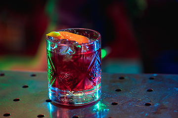 Image showing Close up of alcoholic cocktail, beverage, drink in multicolored neon light