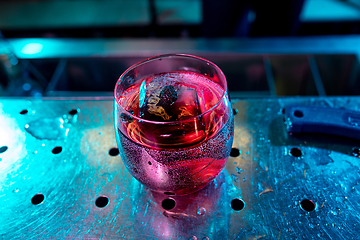 Image showing Close up of alcoholic cocktail, beverage, drink in multicolored neon light