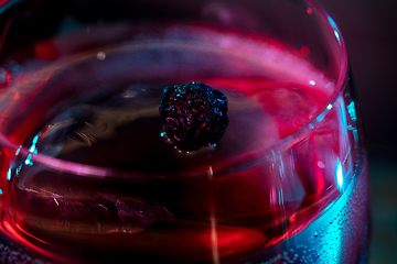 Image showing Close up of alcoholic cocktail, beverage, drink in multicolored neon light