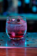 Image showing Close up of alcoholic cocktail, beverage, drink in multicolored neon light
