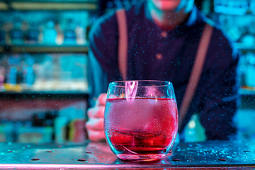 Image showing Close up of alcoholic cocktail, beverage, drink in multicolored neon light