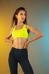 Image showing Fashion portrait of young fit and sportive woman on gradient background. Perfect body ready for summertime.