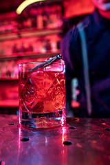 Image showing Close up of alcoholic cocktail, beverage, drink, glass full of ice in multicolored neon light