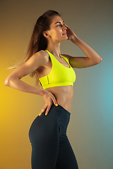 Image showing Fashion portrait of young fit and sportive woman on gradient background. Perfect body ready for summertime.