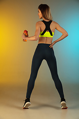 Image showing Fashion portrait of young fit and sportive woman on gradient background. Perfect body ready for summertime. Flyer with copyspace.