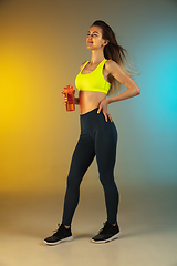 Image showing Fashion portrait of young fit and sportive woman on gradient background. Perfect body ready for summertime. Flyer with copyspace.