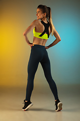 Image showing Fashion portrait of young fit and sportive woman on gradient background. Perfect body ready for summertime.