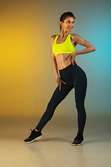 Image showing Fashion portrait of young fit and sportive woman on gradient background. Perfect body ready for summertime.