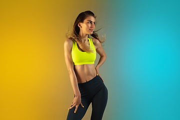 Image showing Fashion portrait of young fit and sportive woman on gradient background. Perfect body ready for summertime.