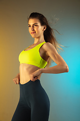 Image showing Fashion portrait of young fit and sportive woman on gradient background. Perfect body ready for summertime.