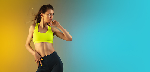 Image showing Fashion portrait of young fit and sportive woman on gradient background. Perfect body ready for summertime. Flyer with copyspace.