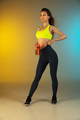 Image showing Fashion portrait of young fit and sportive woman on gradient background. Perfect body ready for summertime. Flyer with copyspace.