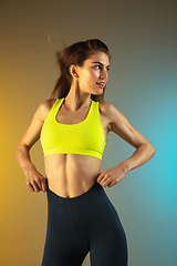 Image showing Fashion portrait of young fit and sportive woman on gradient background. Perfect body ready for summertime.