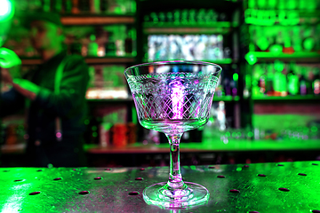 Image showing Close up of graceful drinking glass on a bar counter, preparation for a cocktail