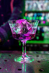 Image showing Close up of alcoholic cocktail, beverage, drink, prepared by professional barman in multicolored neon light