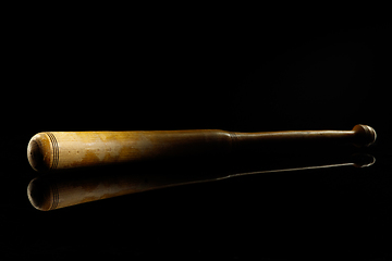 Image showing Professional sport equipment isolated on black studio background. Baseball bat.