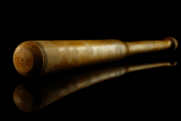 Image showing Professional sport equipment isolated on black studio background. Baseball bat.