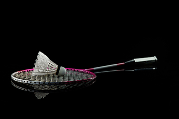 Image showing Professional sport equipment isolated on black studio background. Badminton racket.